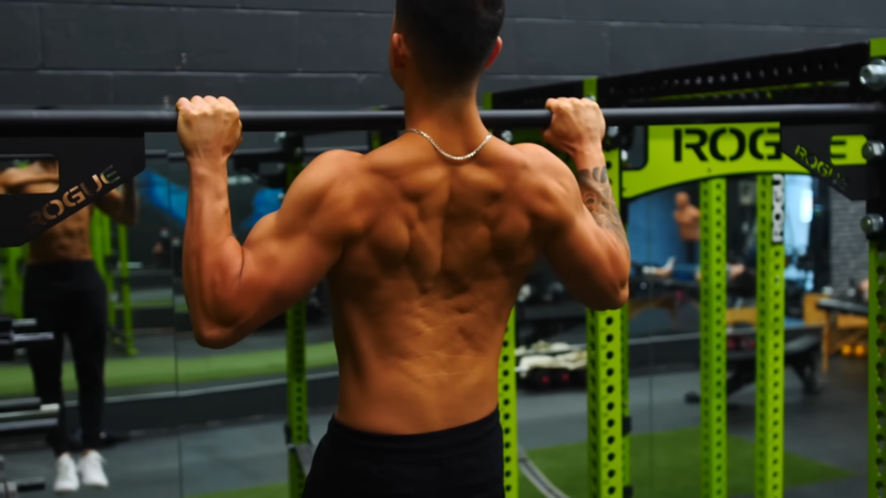 A Man Performing Pull-Ups in The Gym, Focusing on Building Muscular Endurance