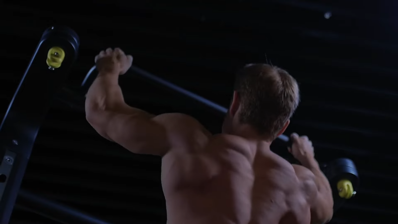 A Man Performing Pull-Ups in A Gym